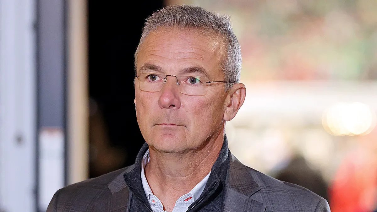 The Physical and Mental Demands of Elite College Coaching, Which Urban Meyer Rules Out Coaching Comeback to Avoid A college football coach looks exhausted and focused on the sideline.