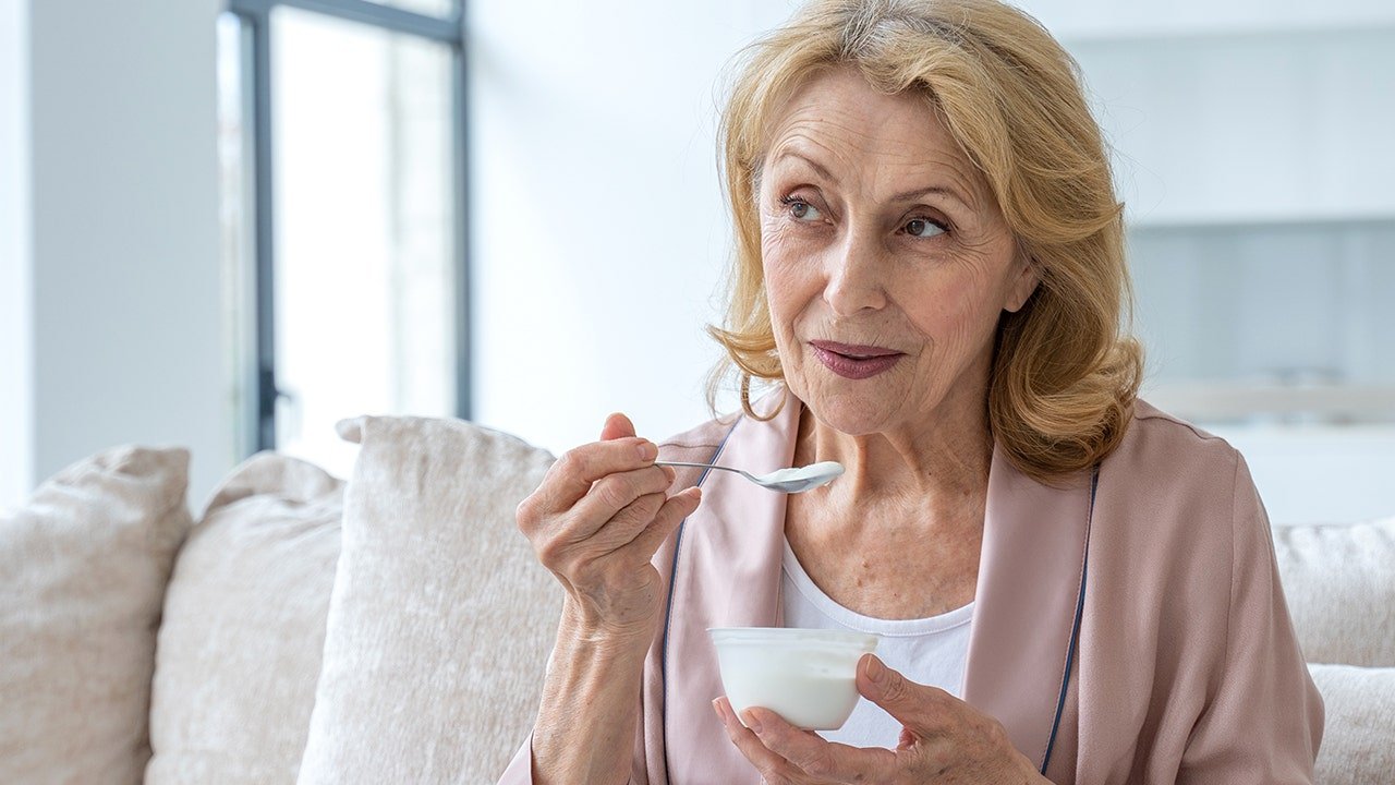 Various dairy products like milk, cheese, and yogurt displayed on a wooden surface.