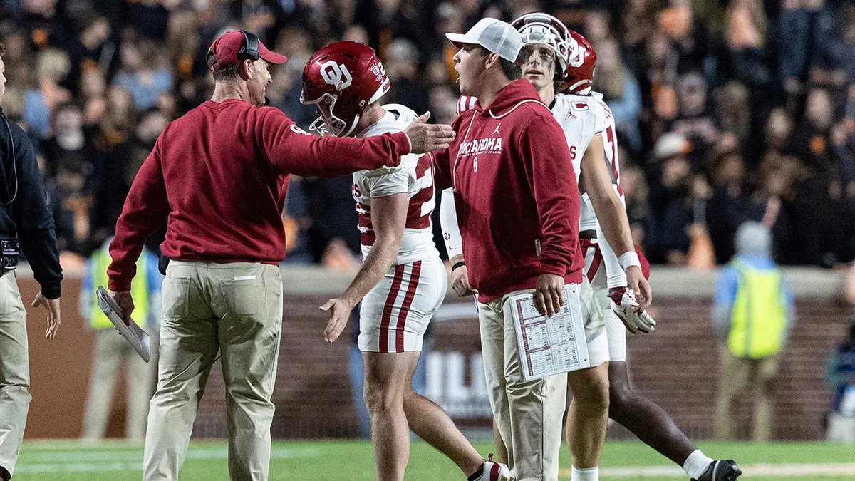 Oklahoma kicker Tate Sandell lining up a field goal attempt while wearing his signature short shorts.