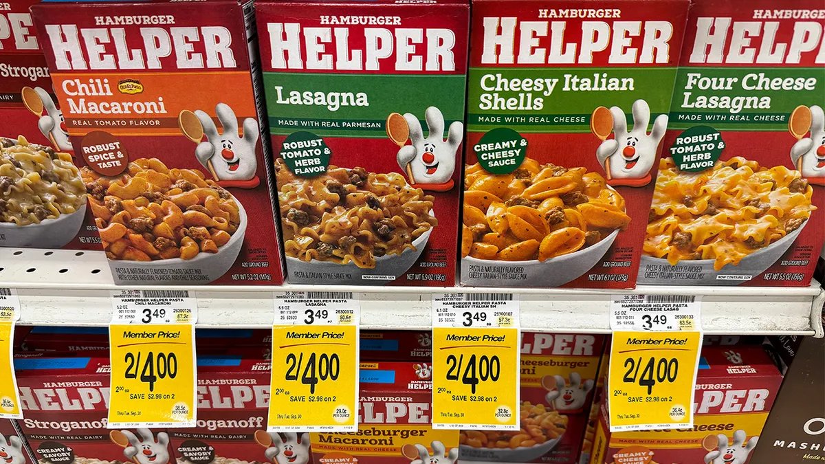 Assortment of Hamburger Helper boxes in a cart