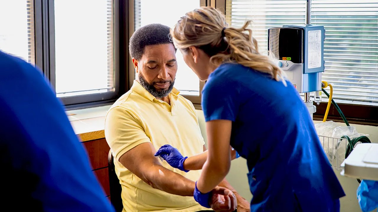 Scientist examining a blood sample, representing early cancer detection.