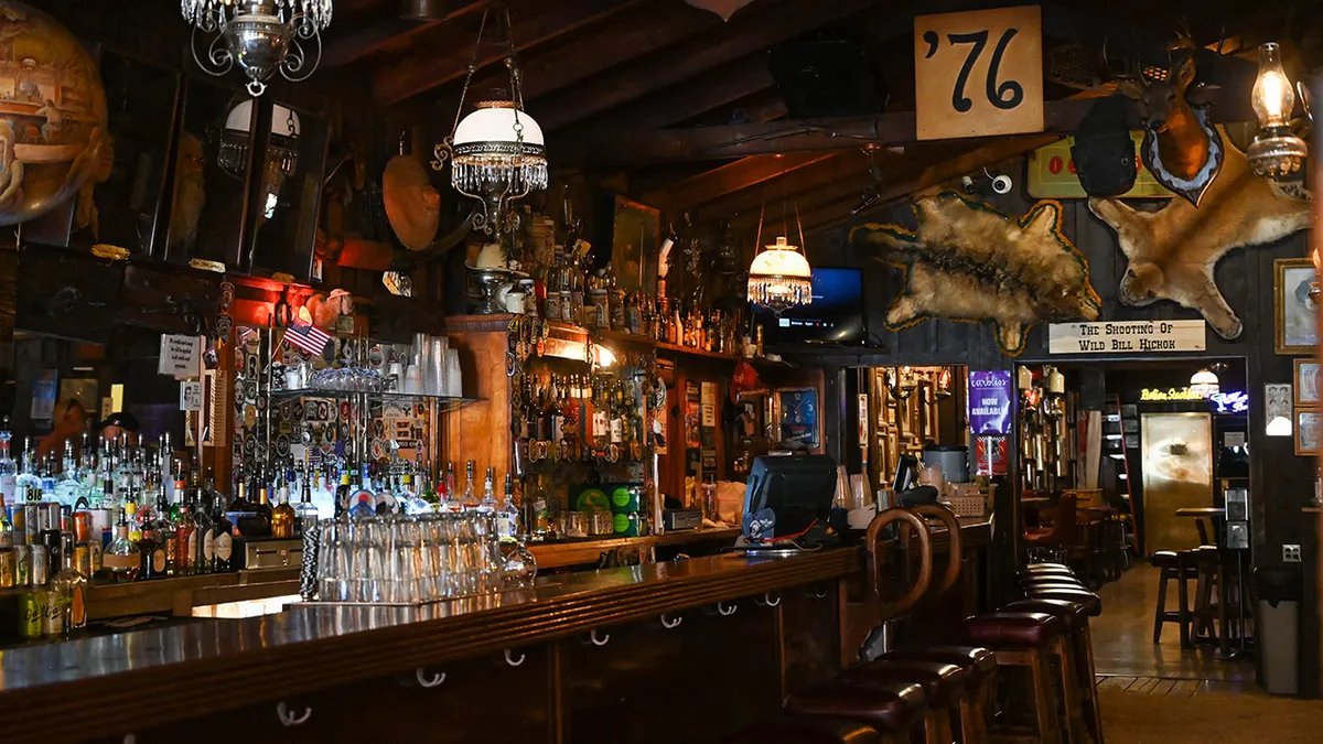 A diverse group of people enjoying themselves at a dive bar