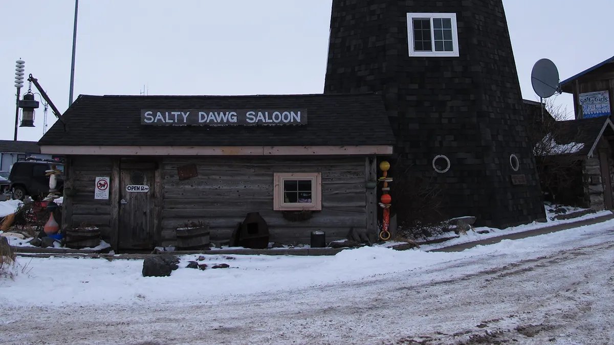 Bartender serving a beer in a dimly lit dive bar