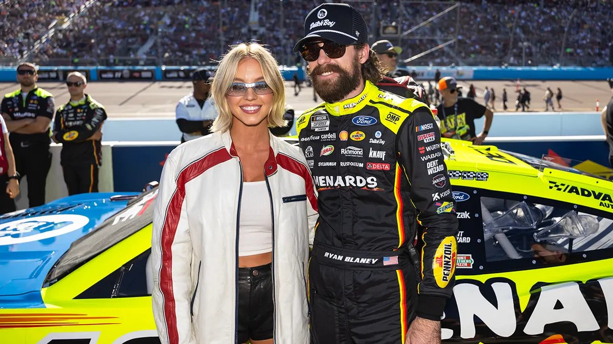 Sydney Sweeney waving to NASCAR fans