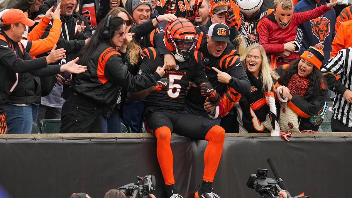 Colston Loveland high-fiving a coach after the game