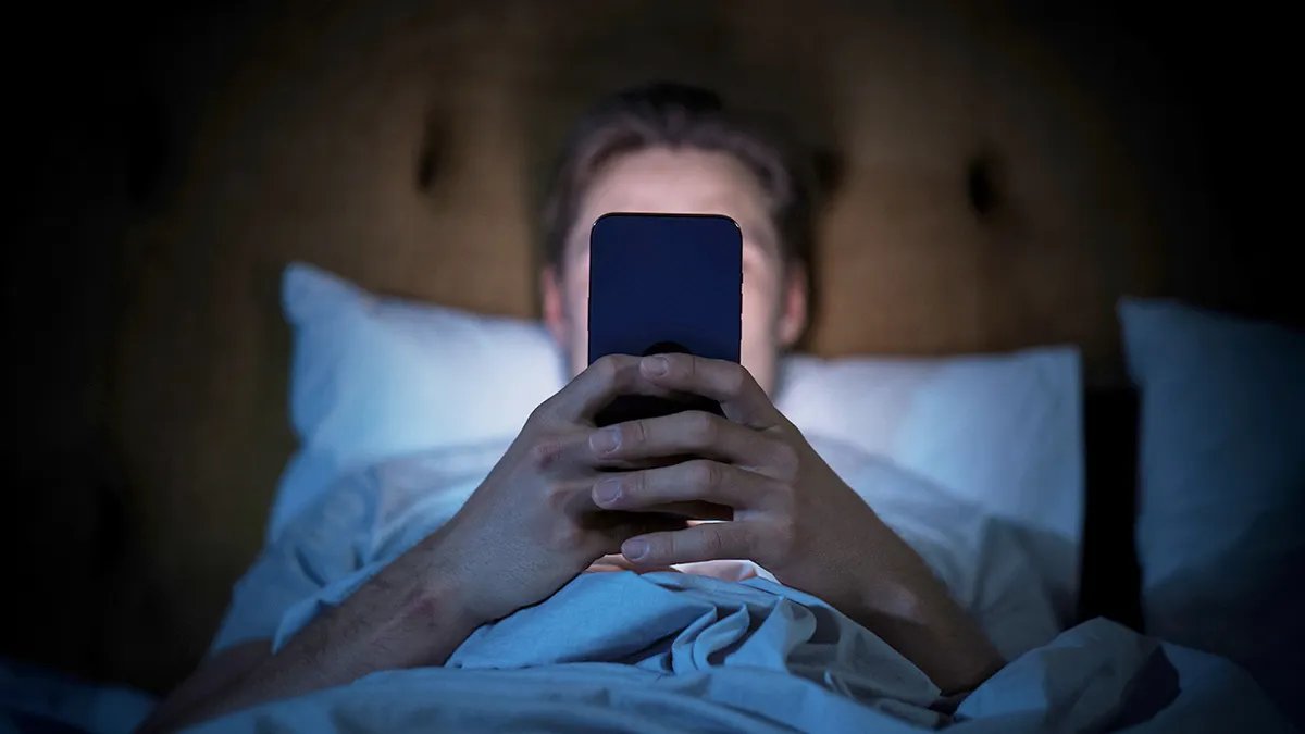 Optimizing your sleep environment for better sleep quality Dark bedroom with a comfortable bed, ideal for sleep