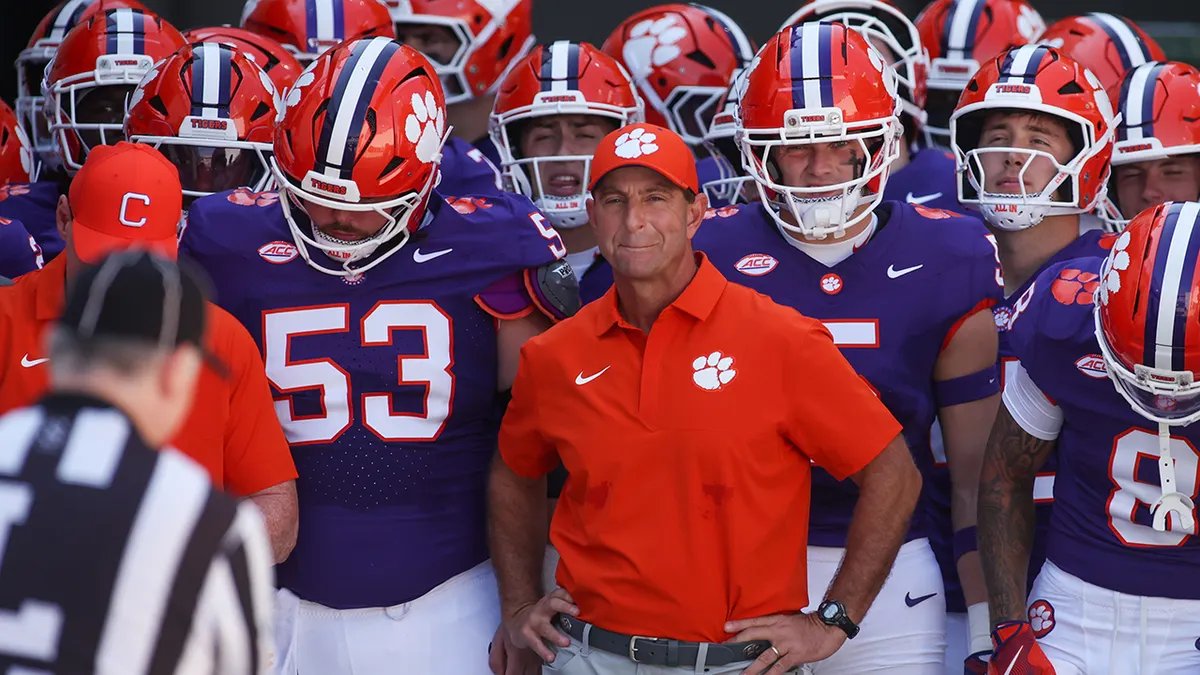 Dabo Swinney coaching his player during a Clemson game Dabo Swinney talking to a player on the sidelines