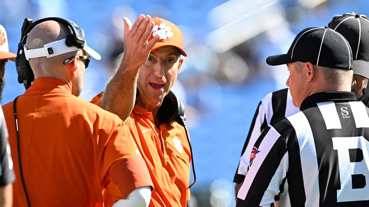 Dabo Swinney arguing with a referee during a Clemson game Dabo Swinney animatedly discussing a call with a referee