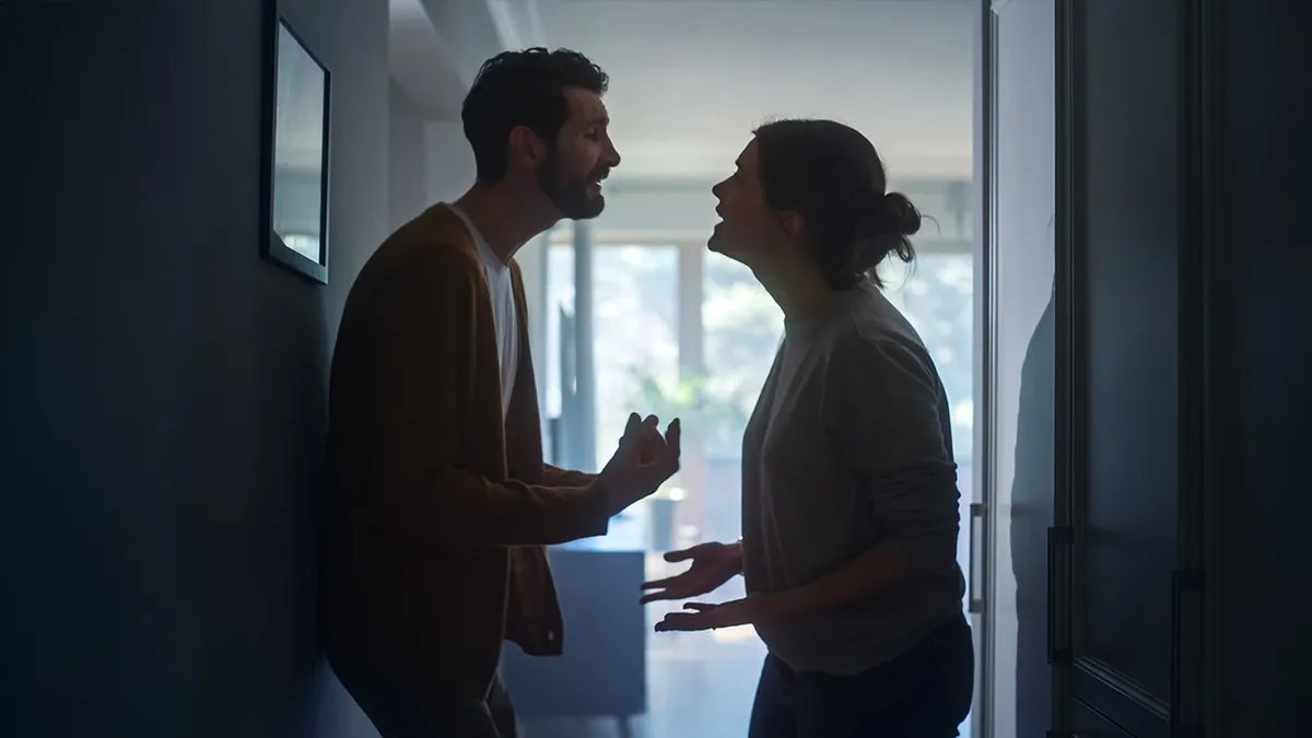 A couple preparing lunch together in a kitchen.