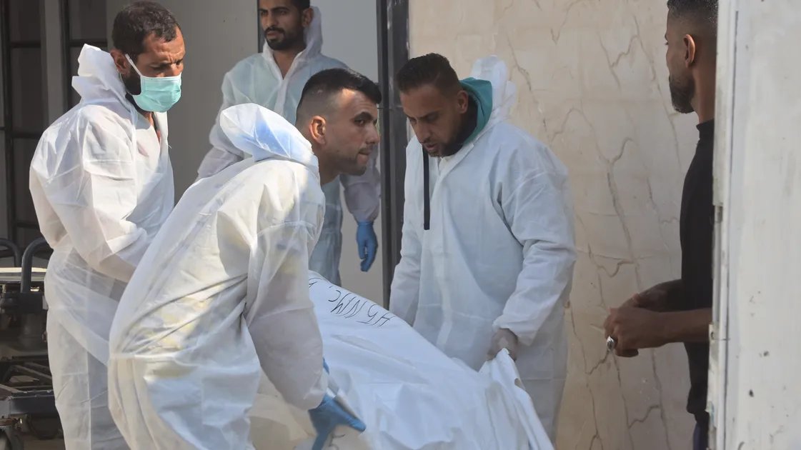 Palestinians search through the rubble of destroyed buildings in Gaza.
