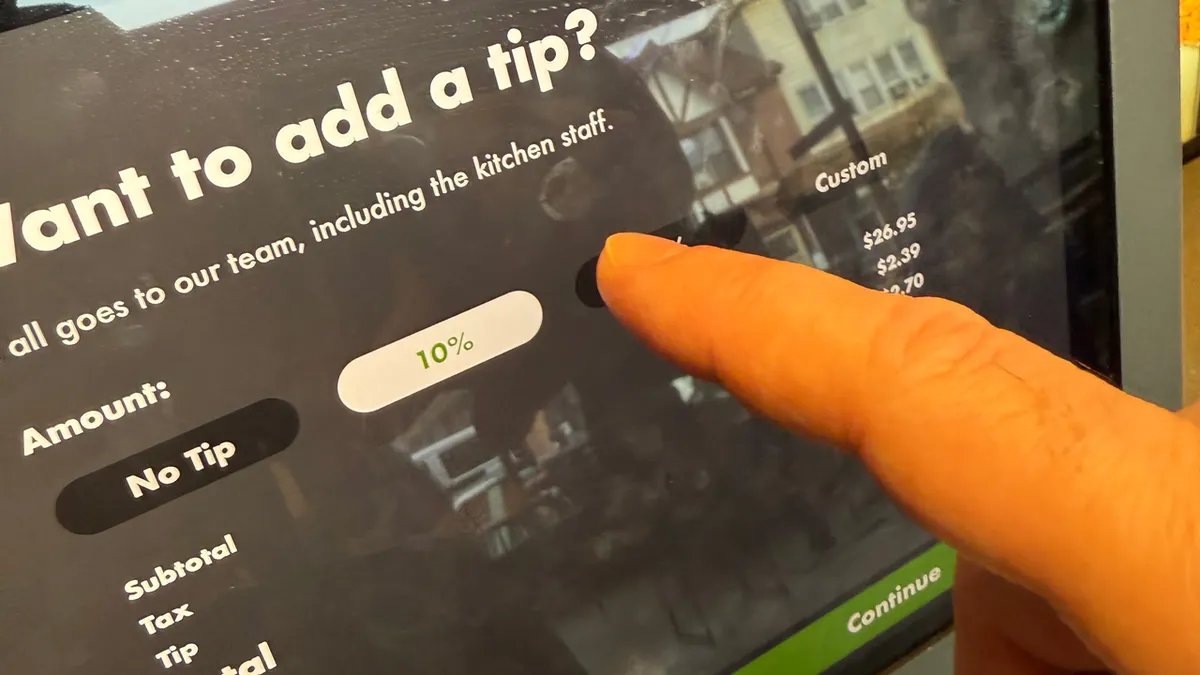 A restaurant staff meeting, symbolizing discussions around compensation and service models.