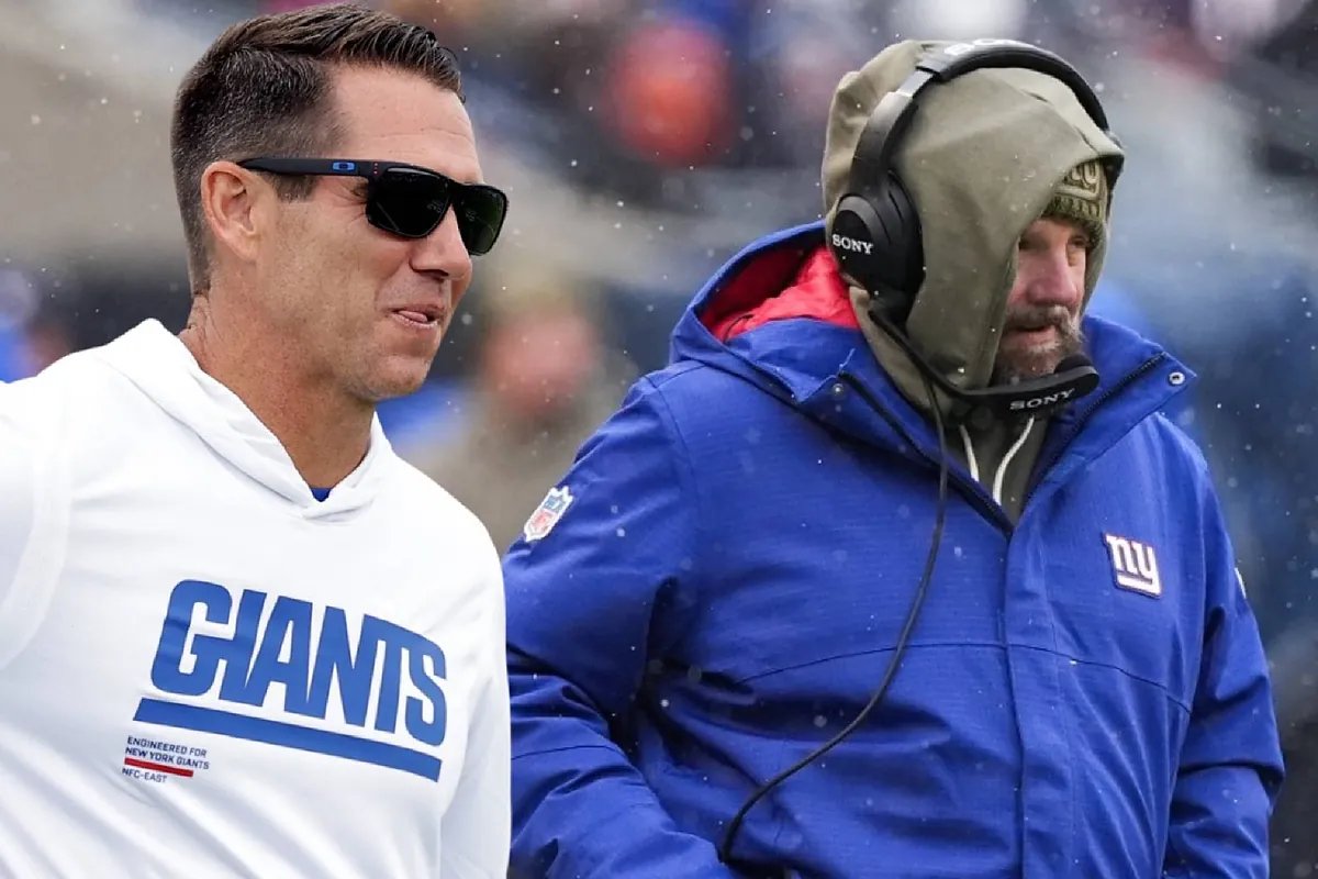 Joe Schoen stands on the sidelines during a Giants game, looking pensive.