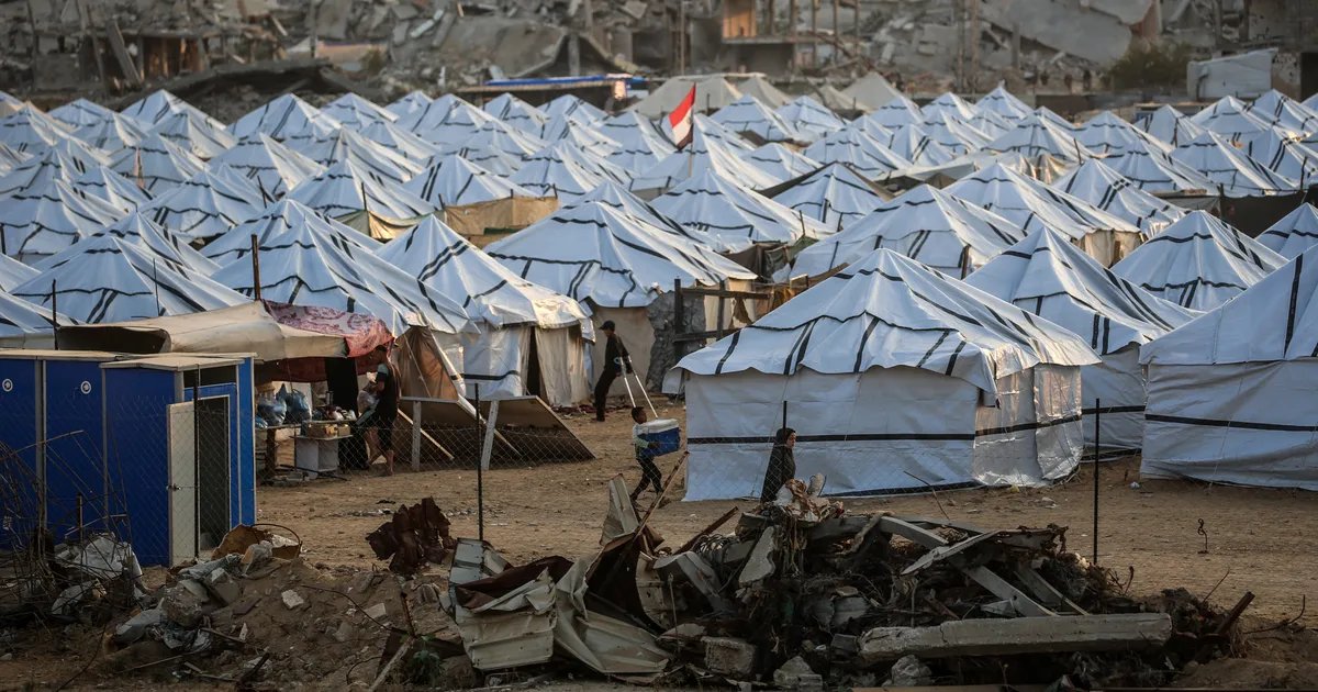 A somber view of the heavily blockaded Gaza Strip coastline, with dilapidated buildings stretching into the distance under a grey sky, symbolizing its isolation and the humanitarian crisis.