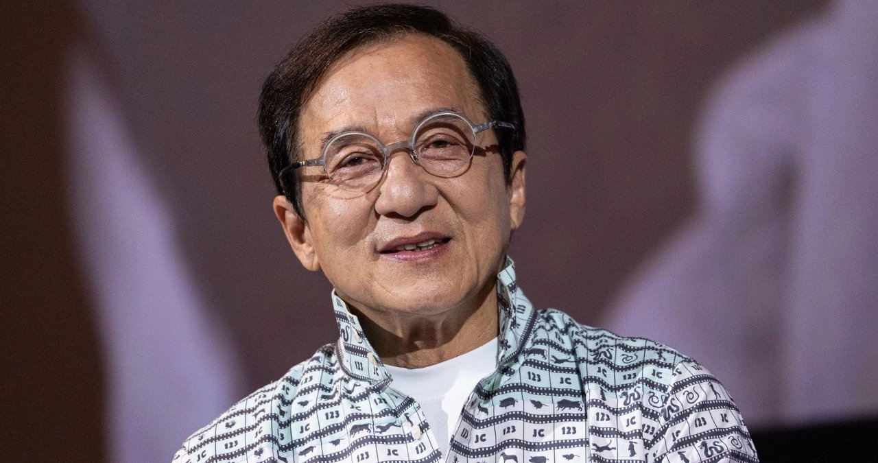 Jackie Chan smiling and waving at a public event, dispelling death rumours.