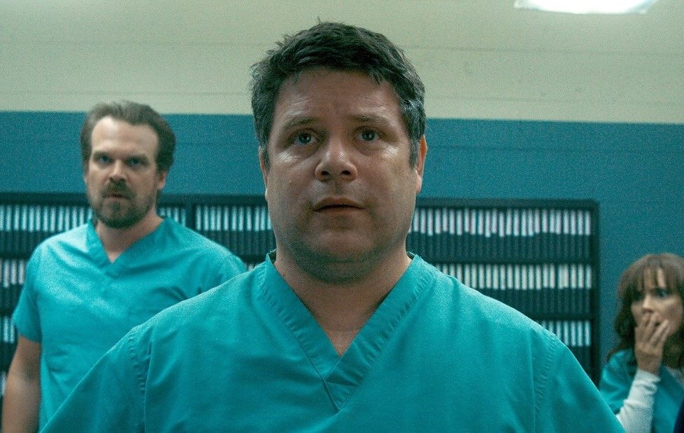 Sadie Sink as Max Mayfield, with her vibrant red hair and a determined expression.