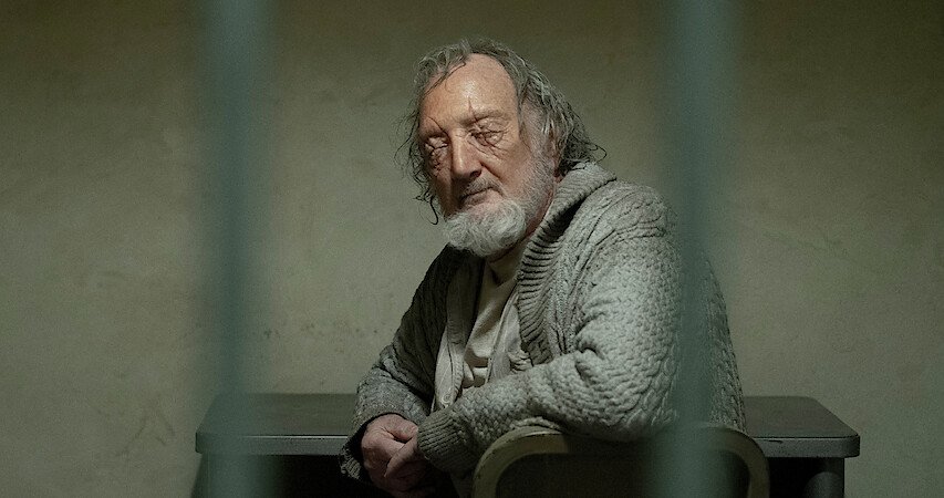 Dacre Montgomery as Billy Hargrove, leaning casually with a challenging smirk.