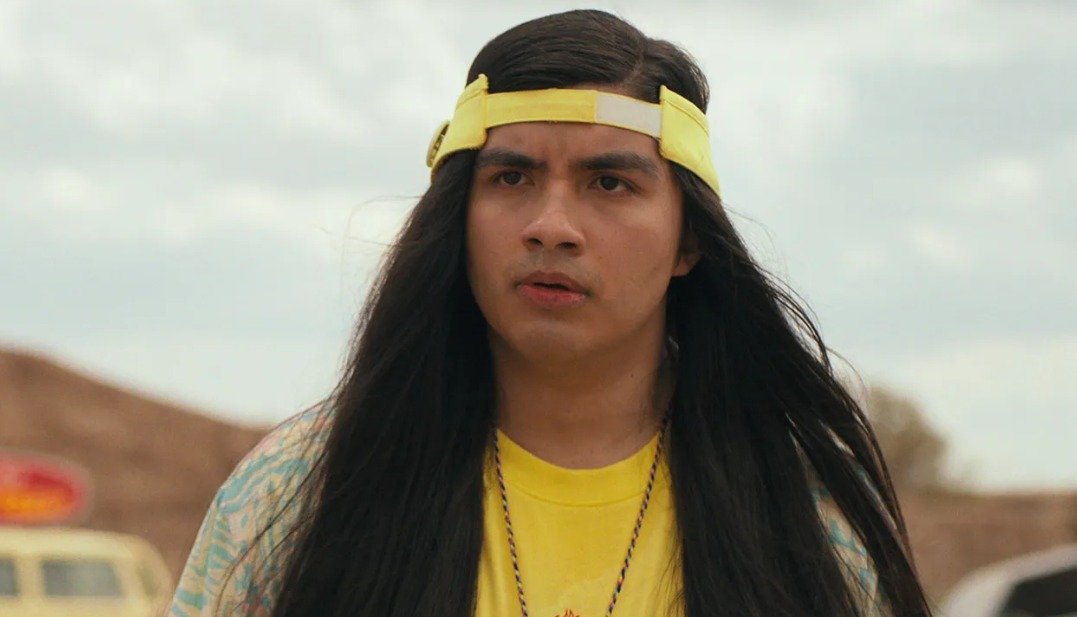 Charlie Heaton as Jonathan Byers, holding a camera and looking pensive.