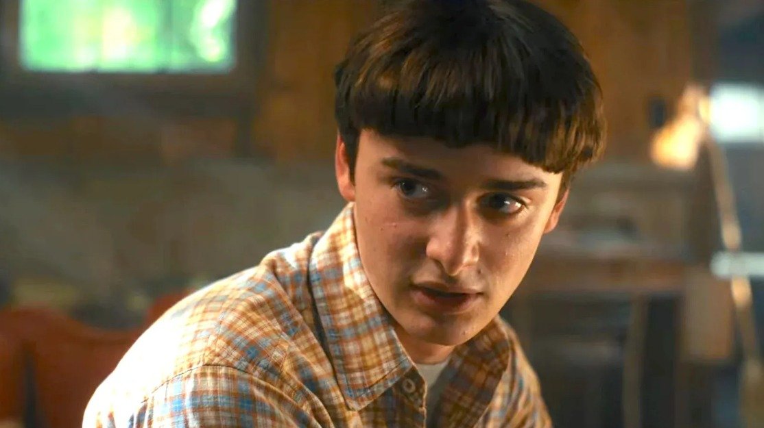 The Stranger Things cast smiling together, showcasing their camaraderie.