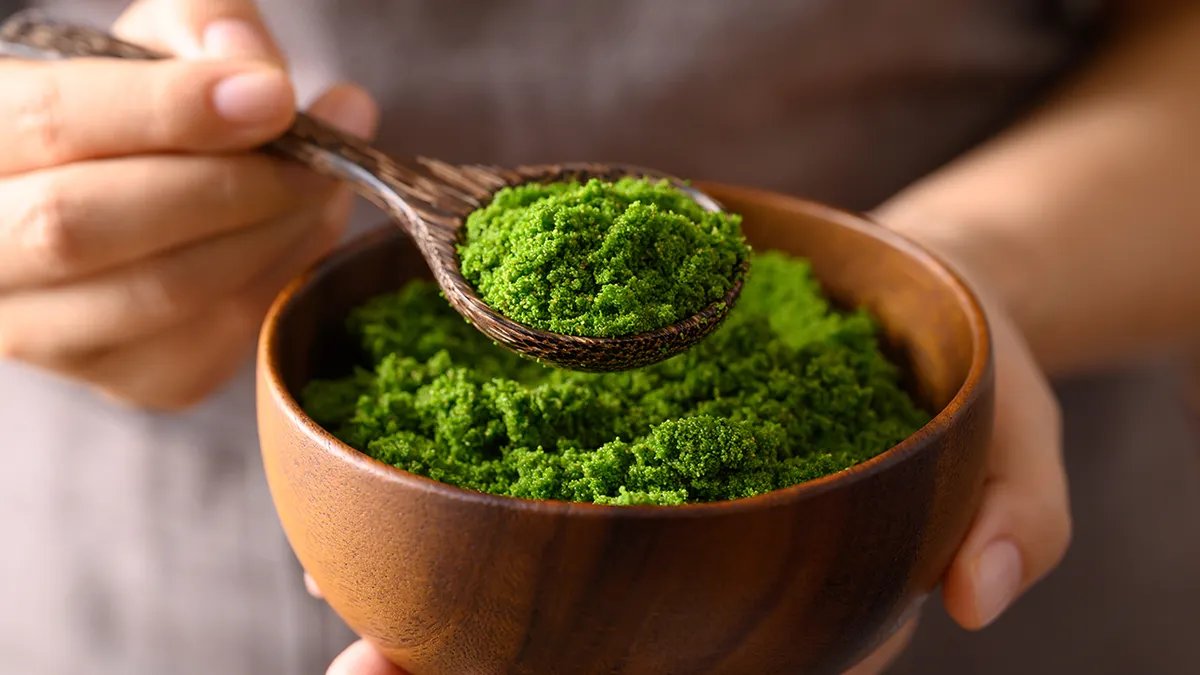 A handful of walnuts in their shells and cracked open, showcasing their brain-like appearance and healthy fats.