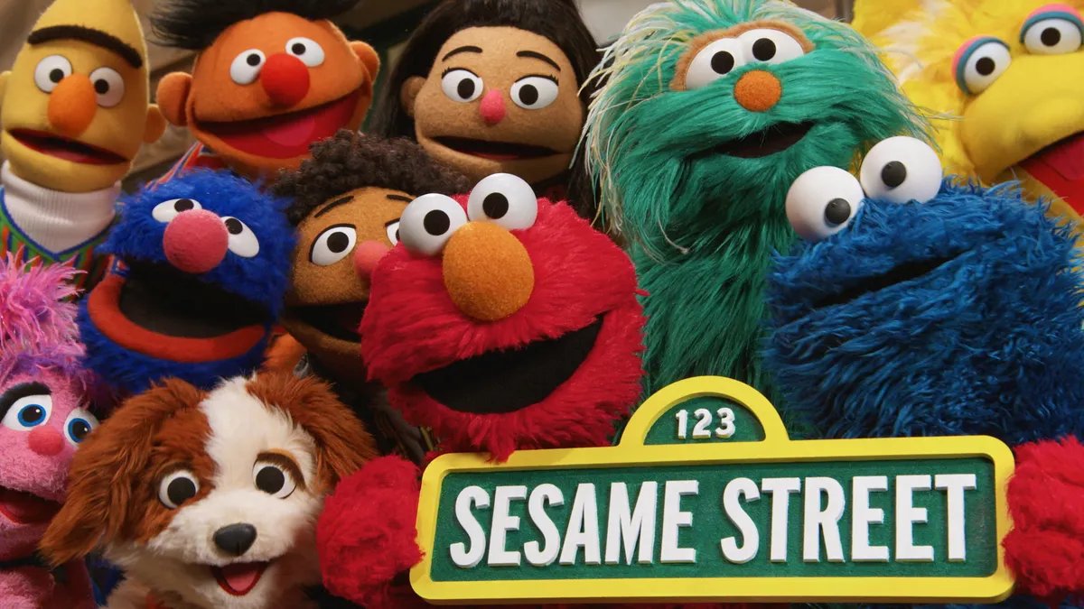 Elmo and Abby Cadabby welcoming children to the modern Sesame Street, reflecting changes in content and pacing for streaming audiences.