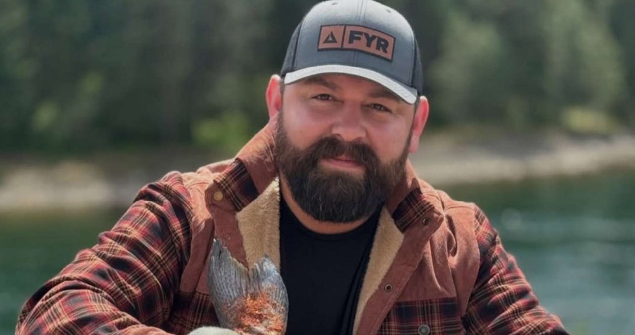 A somber, artistic portrait of Michael Duarte, known as FoodWithBearHands, reflecting on his legacy.