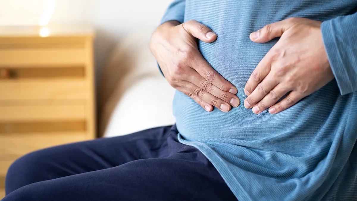A doctor conducting a routine check-up on a male patient, emphasizing the importance of preventative care.