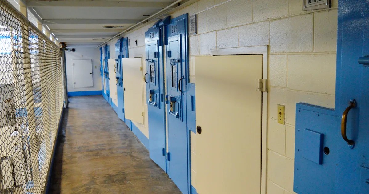 Richard Moore being escorted by officers.