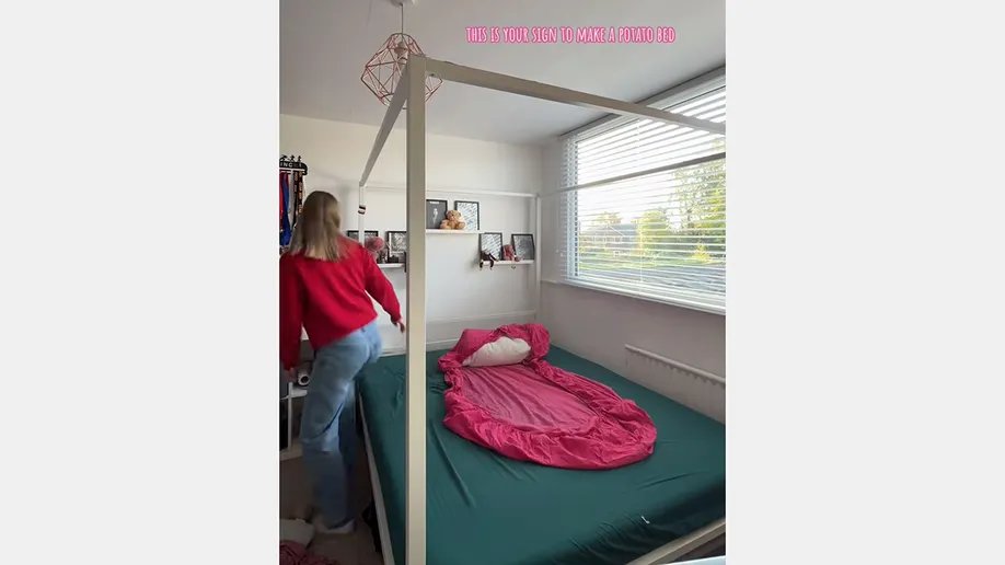 A person's legs and feet comfortably tucked into a thick, textured 'potato bed' with soft blankets, highlighting the cozy enclosure.