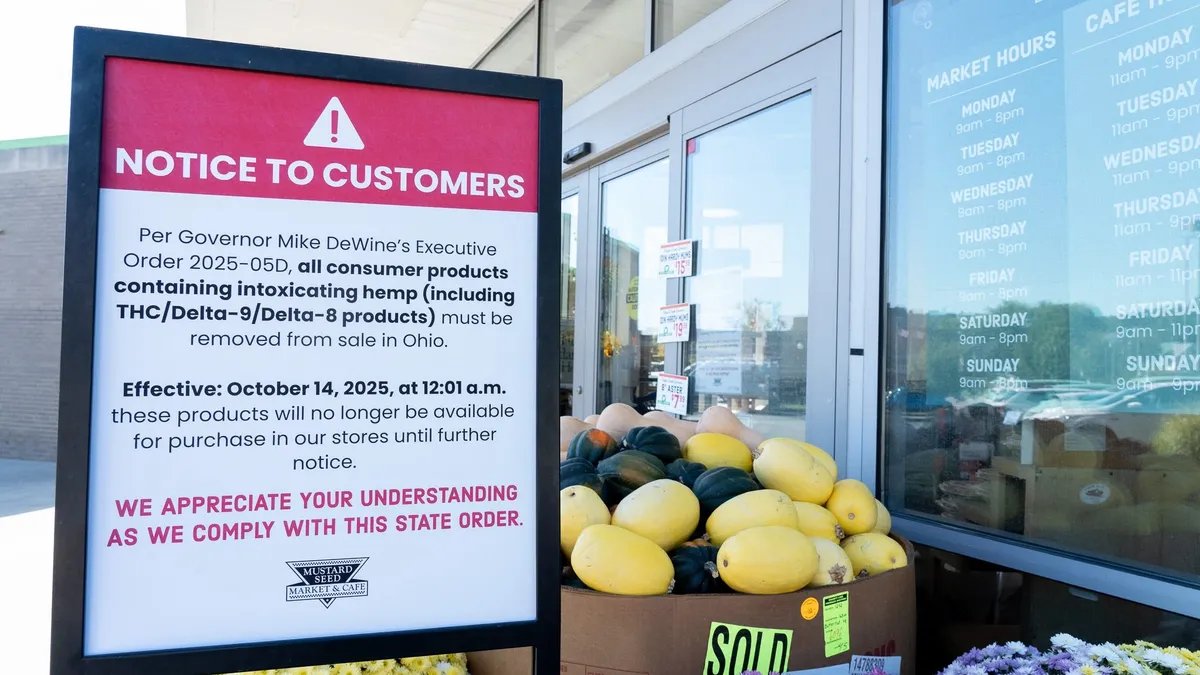 A scientist in a lab coat examining hemp plants under controlled lighting, symbolizing the strict testing and regulatory environment of the hemp industry.