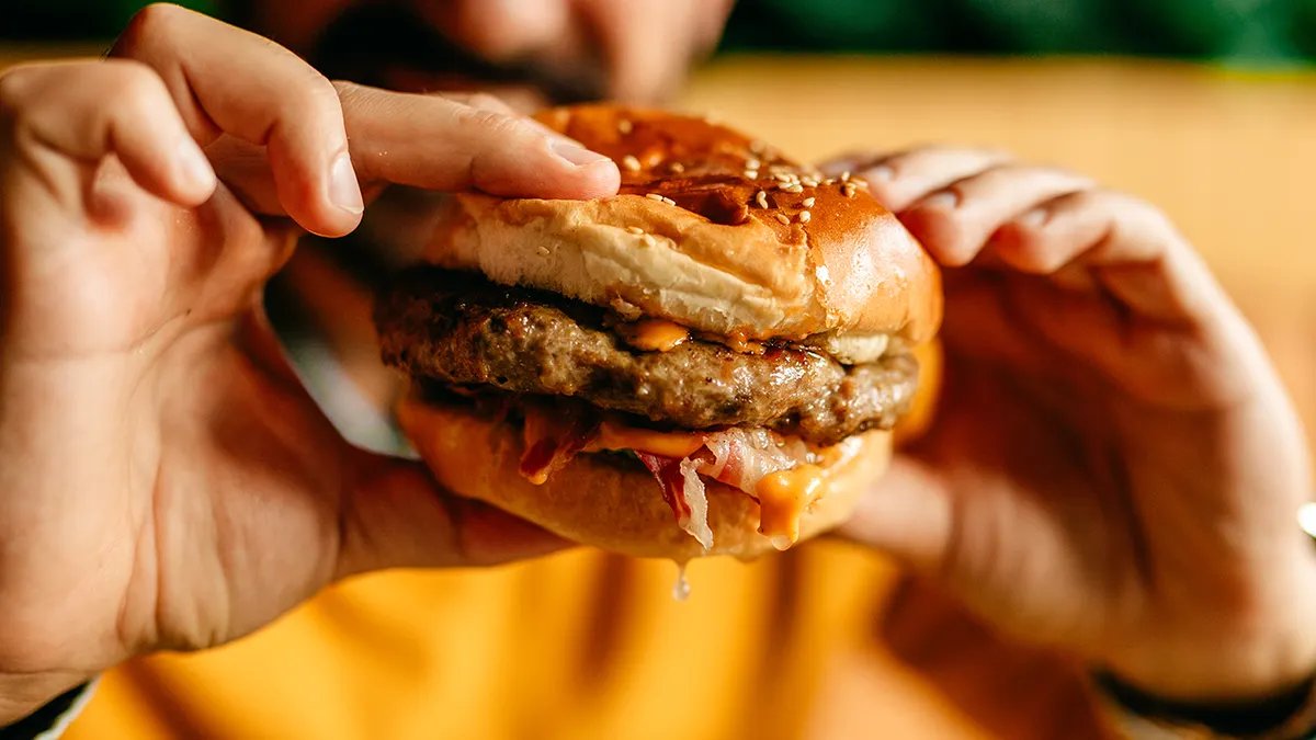 A spread of various fast-food items, including burgers, fries, and drinks, perfect for a meal deal.