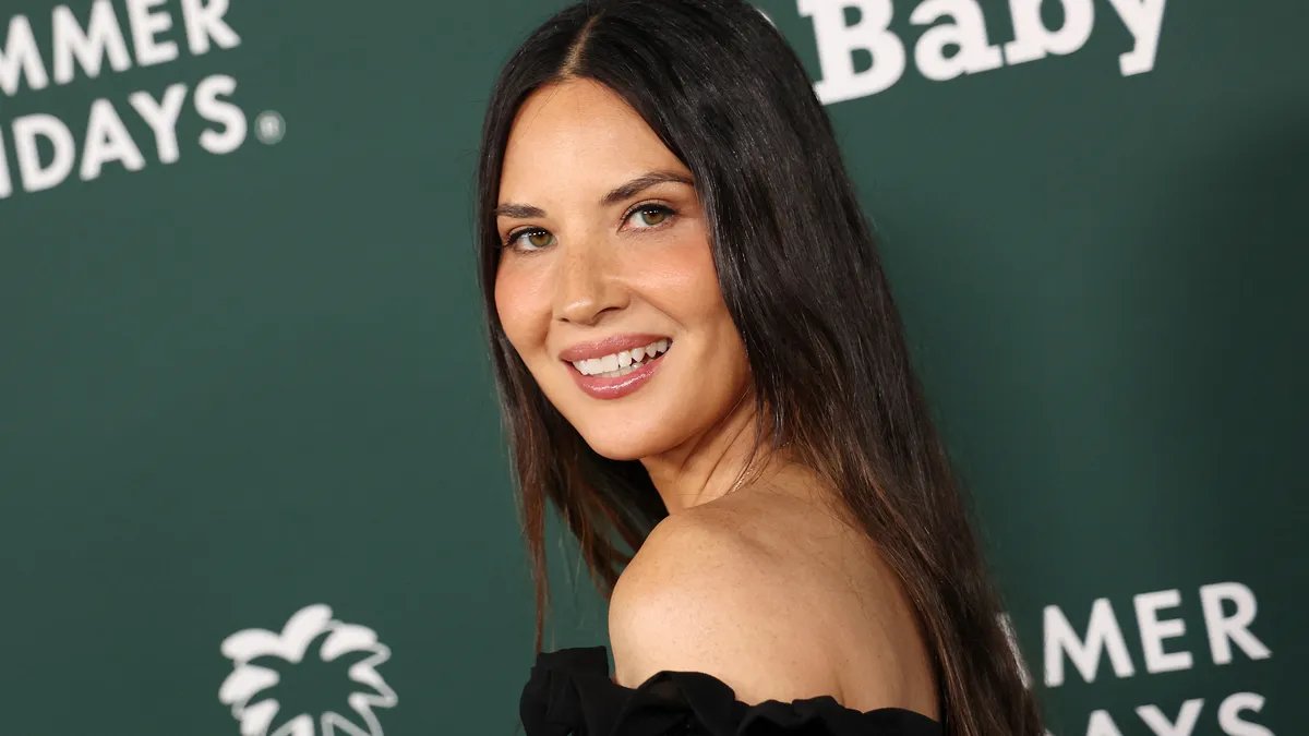 Olivia Munn looking concerned. She is likely thinking about her bout with food poisoning.