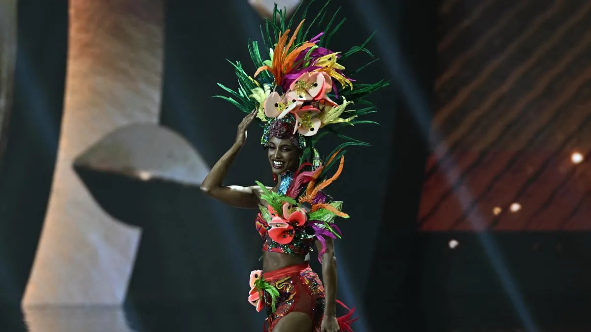 Miss Jamaica lying on the stage after falling during the evening gown competition at Miss Universe