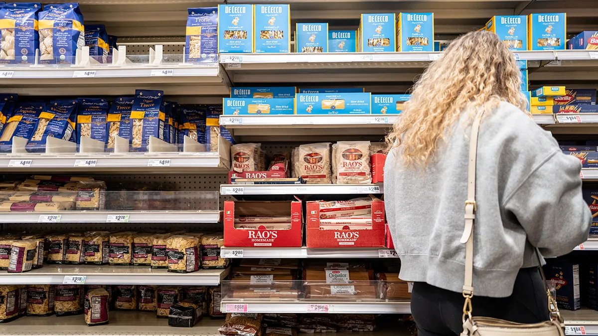 Shelves stocked with various brands of American pasta.