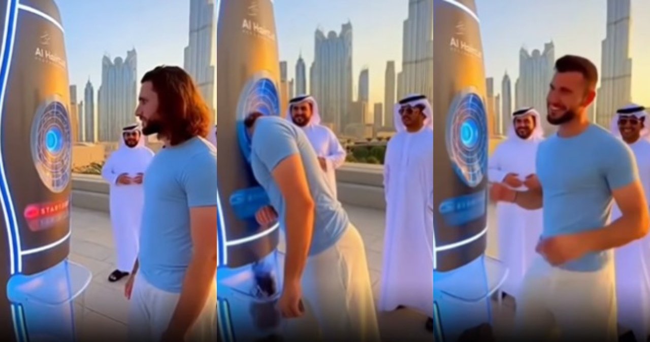 A still from the viral video showing a person inside a sleek, futuristic haircutting pod with robotic arms seemingly at work.