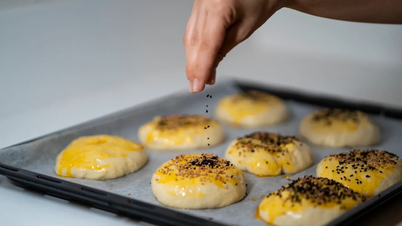 A close-up shot of ground turmeric, highlighting its vibrant orange-yellow color.