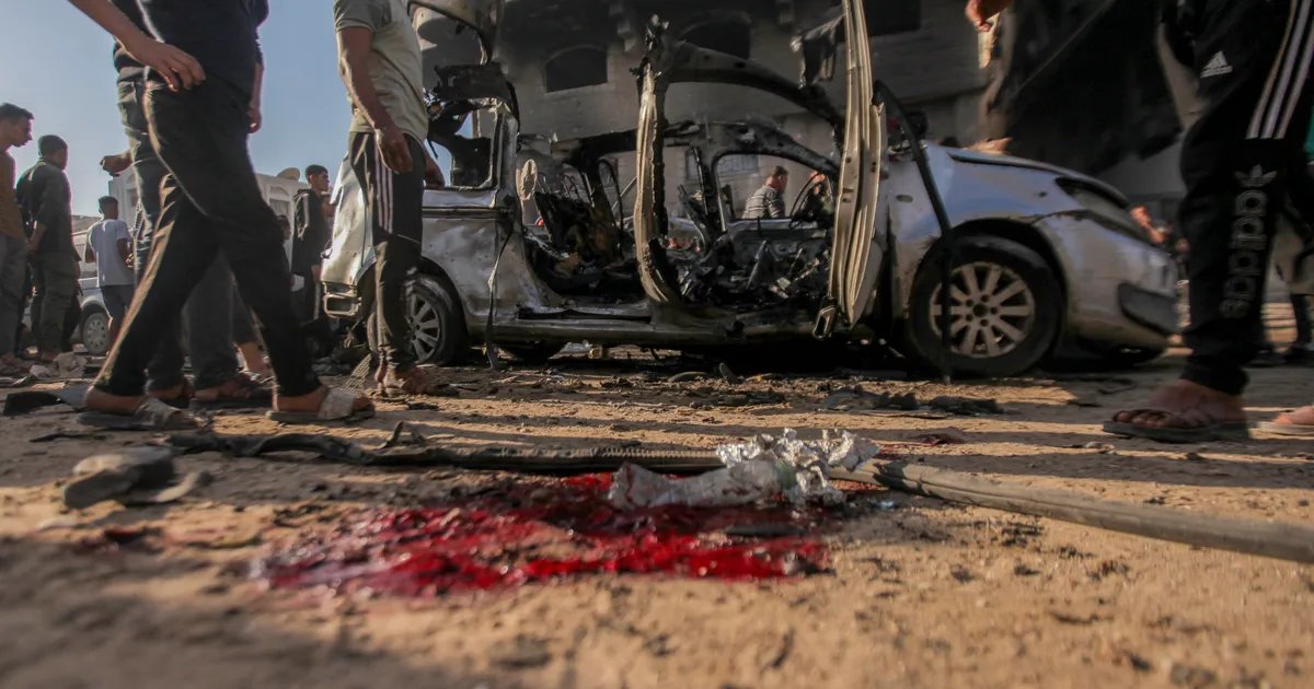 The aftermath of an Israeli strike in Gaza, showing widespread destruction and rescue workers searching for survivors.