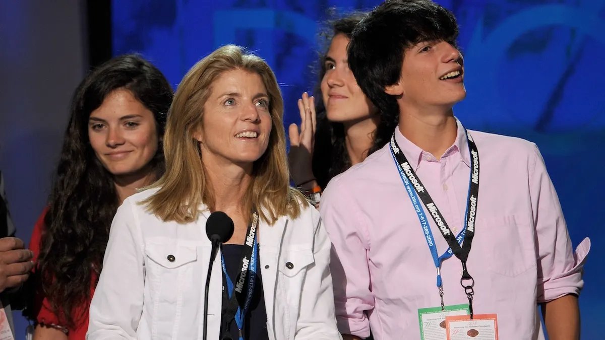 A group of people participating in a cancer awareness walk, symbolizing community support and hope.