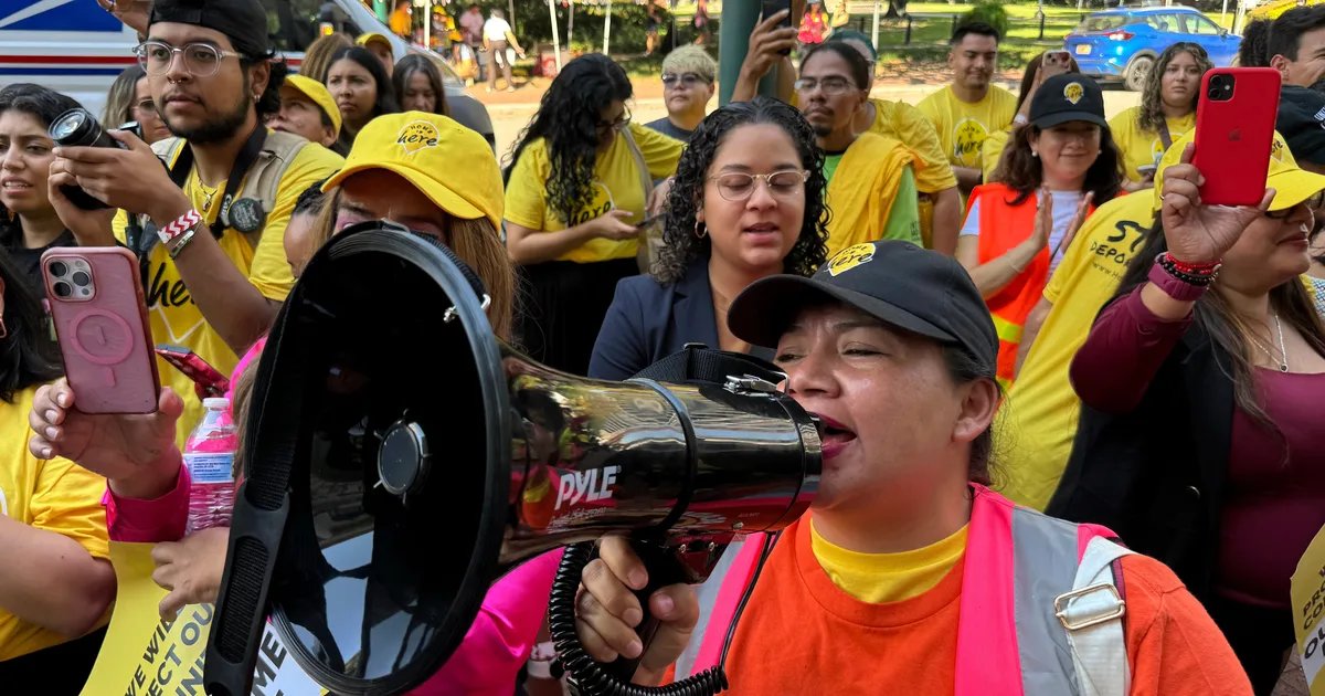 Protestors holding signs advocating for DACA recipients.