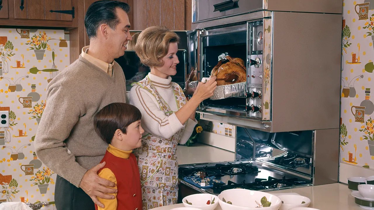 A beautifully set Thanksgiving table with various dishes, including a turkey, side dishes, and desserts.