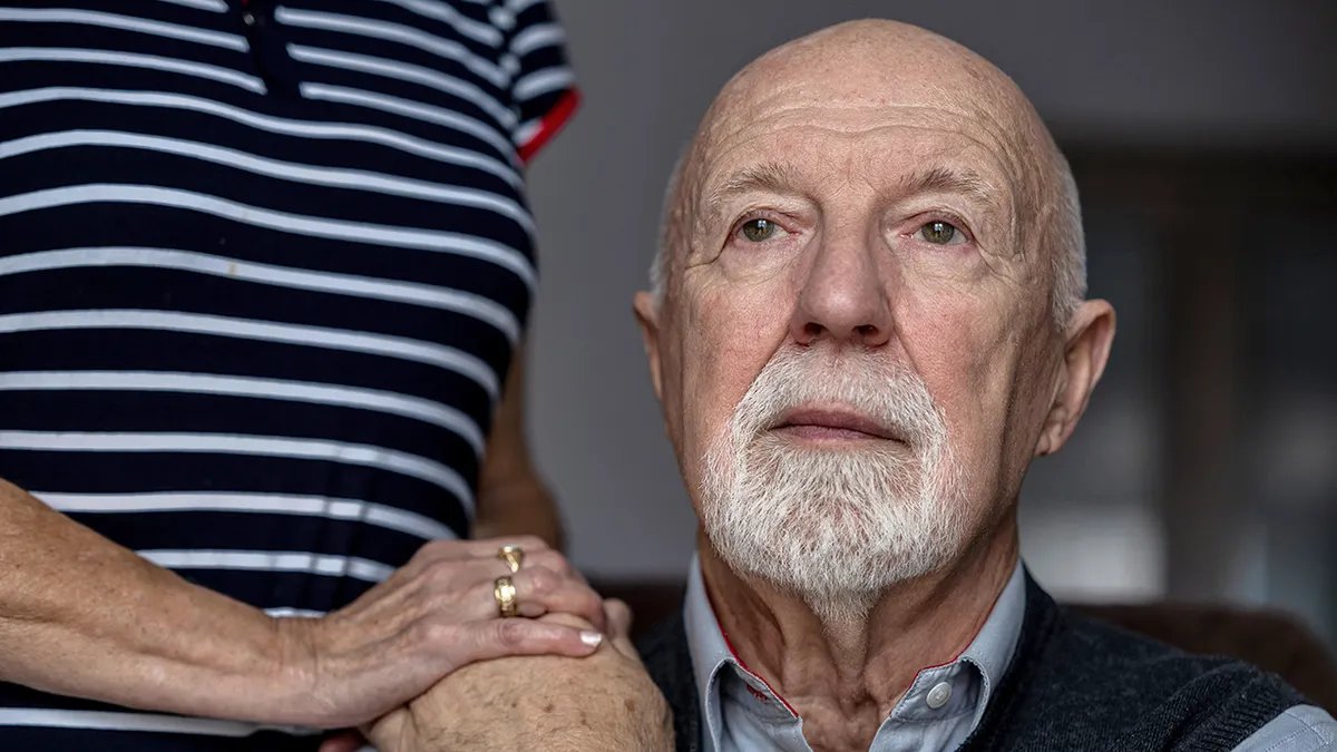 A doctor explaining Parkinson's disease to a patient.