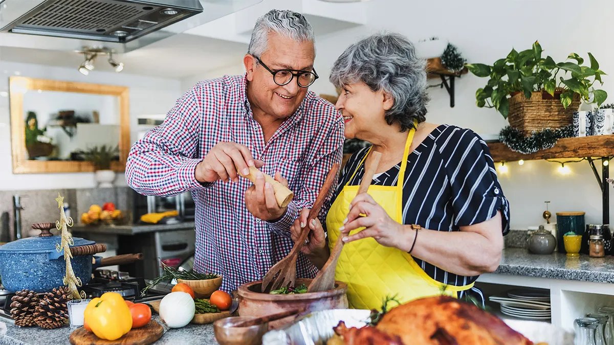 A woman preparing Thanksgiving dinner in a bustling kitchen.