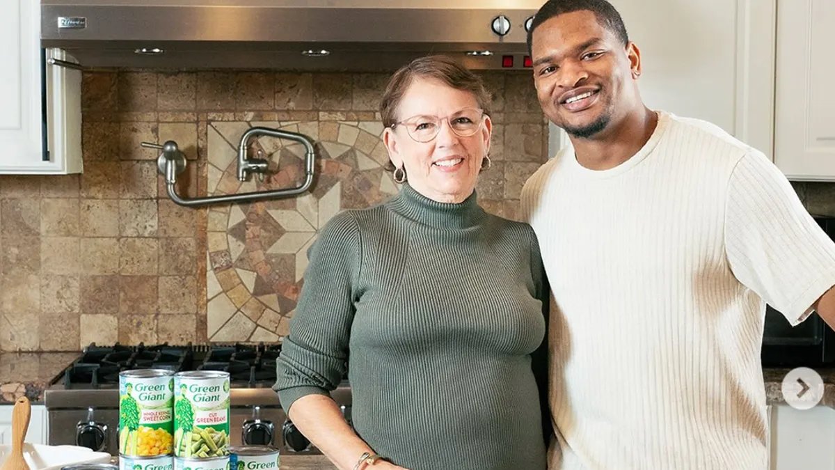 A Thanksgiving table setting with plates, silverware, and decorations.