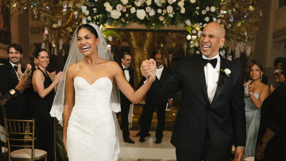 Cory Booker and Alexis Lewis smiling at an event