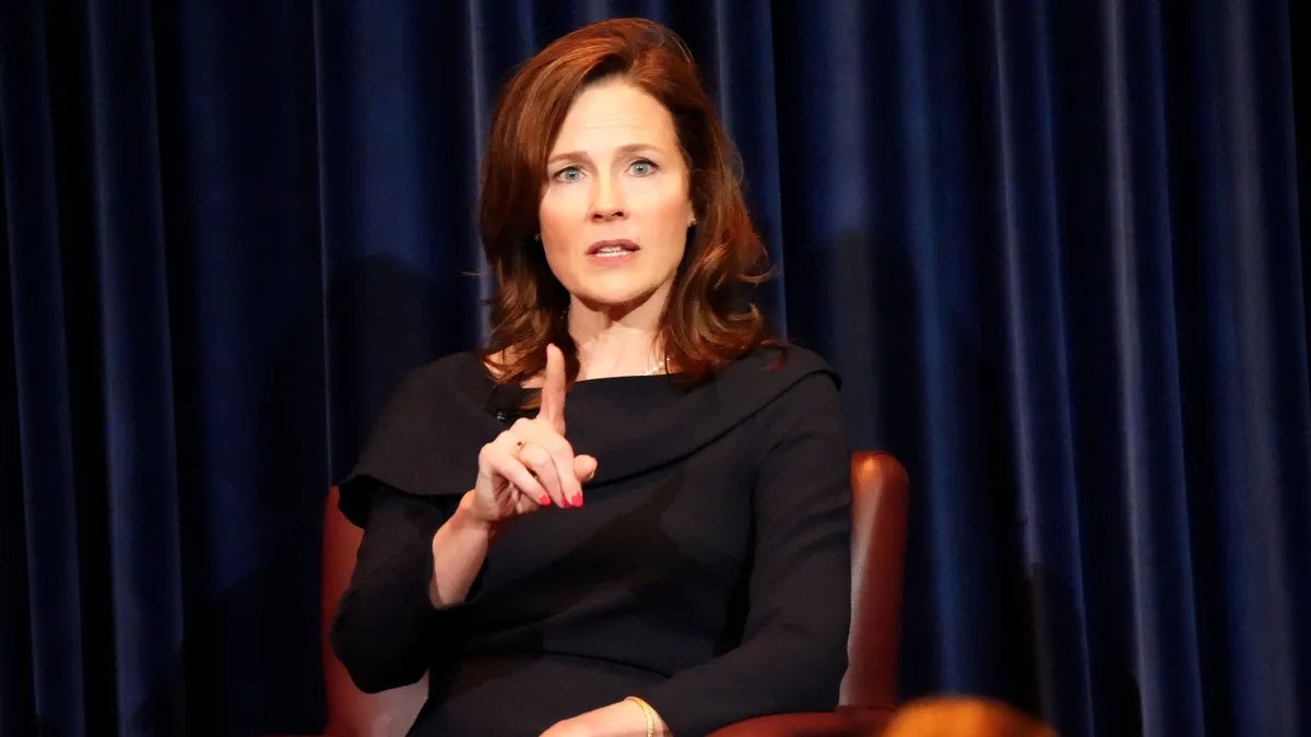 Justice Amy Coney Barrett speaks at a conservative gathering, emphasizing grace and strength.