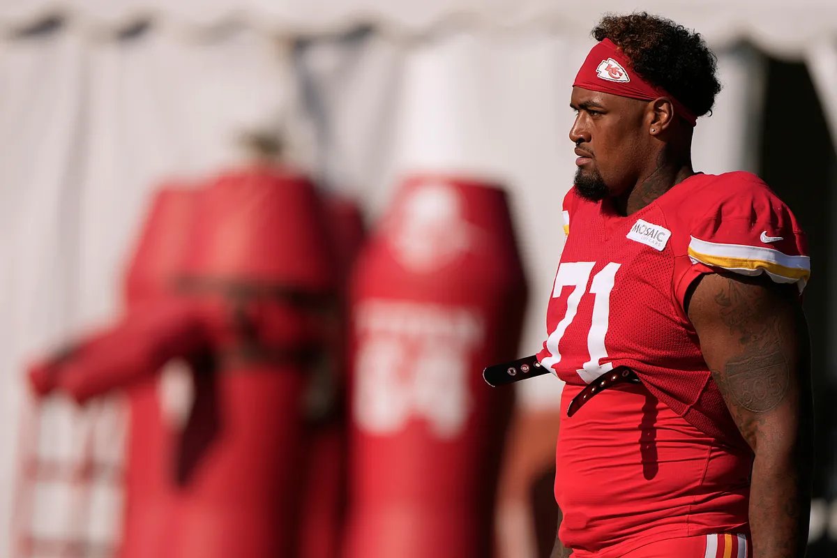 Andy Reid and Patrick Mahomes share a laugh during practice, symbolizing team unity and positive morale.