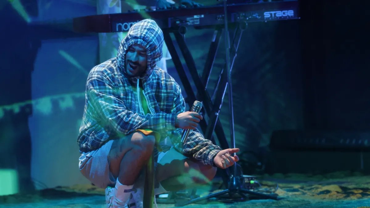 Bad Bunny delivering his impactful speech at the Latin Grammys 2025, holding his award.