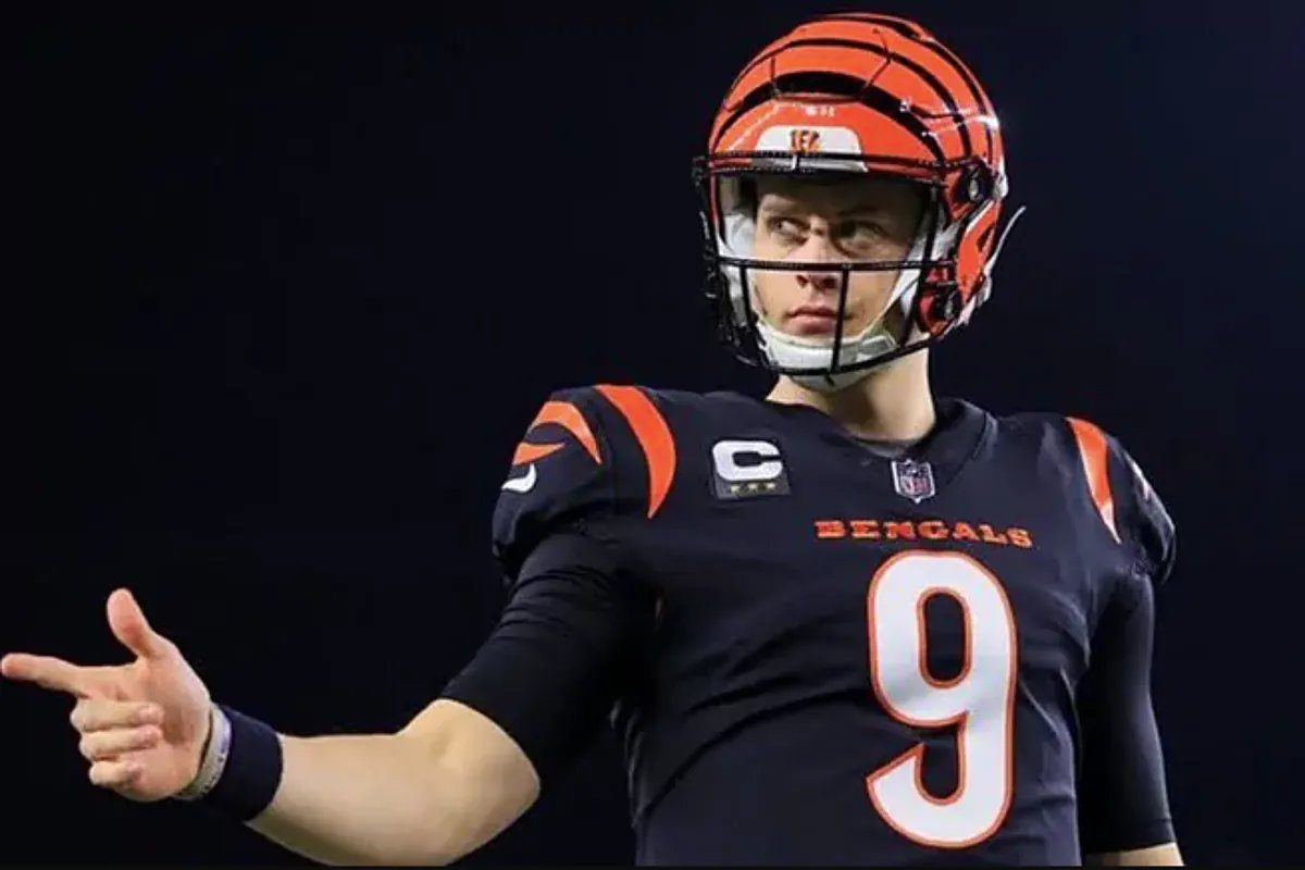 Joe Burrow on the sideline during a Bengals game, looking contemplative.