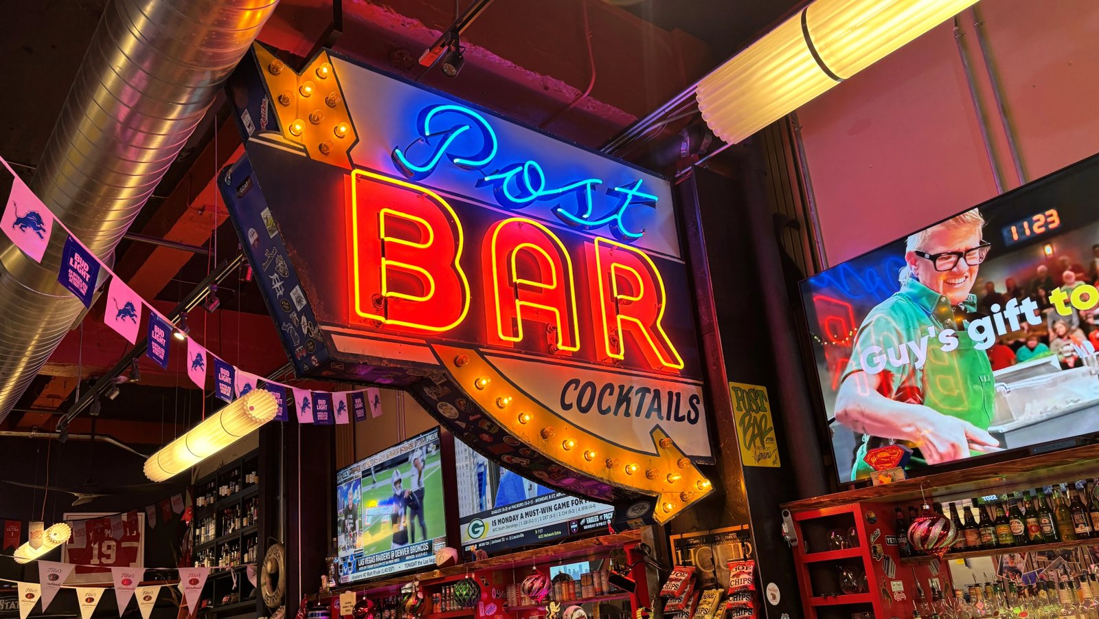 Close-up of a bartender serving a drink in a dive bar.