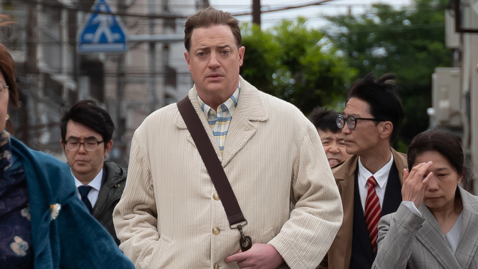 Brendan Fraser smiling during Japanese language lesson.