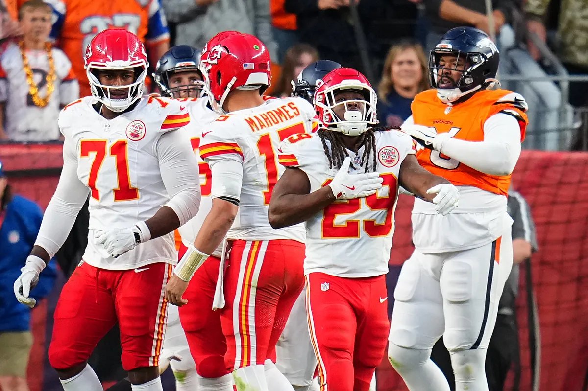 Brett Veach watching a Chiefs game from the sidelines, looking concerned.